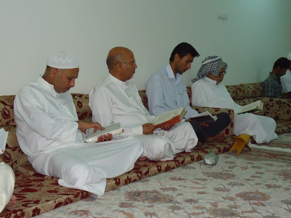 Quran review schedule – men reviewing the Quran together